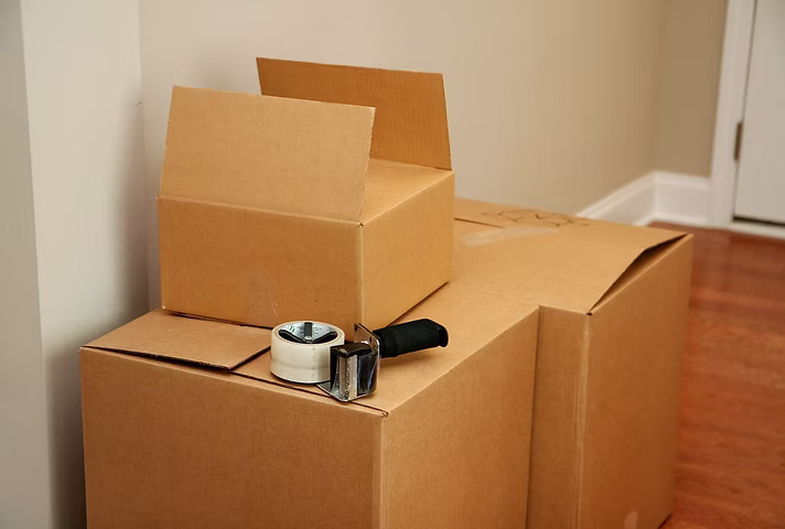 Packing tape dispenser on cardboard moving box