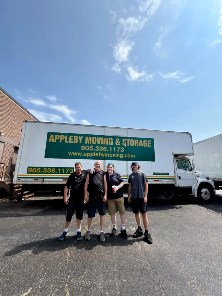 Appleby Moving & Storage crew standing in front of their moving truck at the Burlington yard